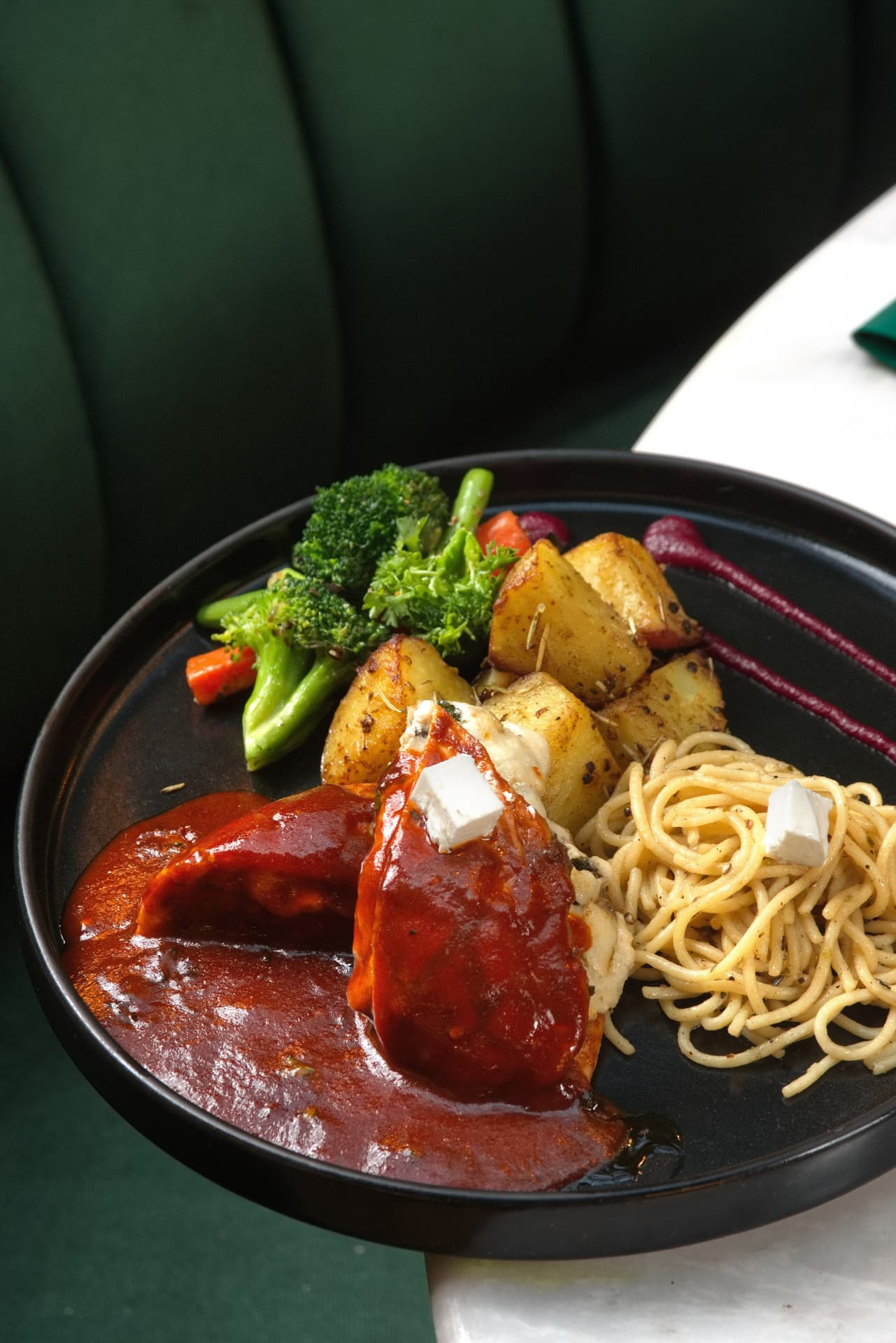 Chicken in signature sauce with pasta and roasted vegetables