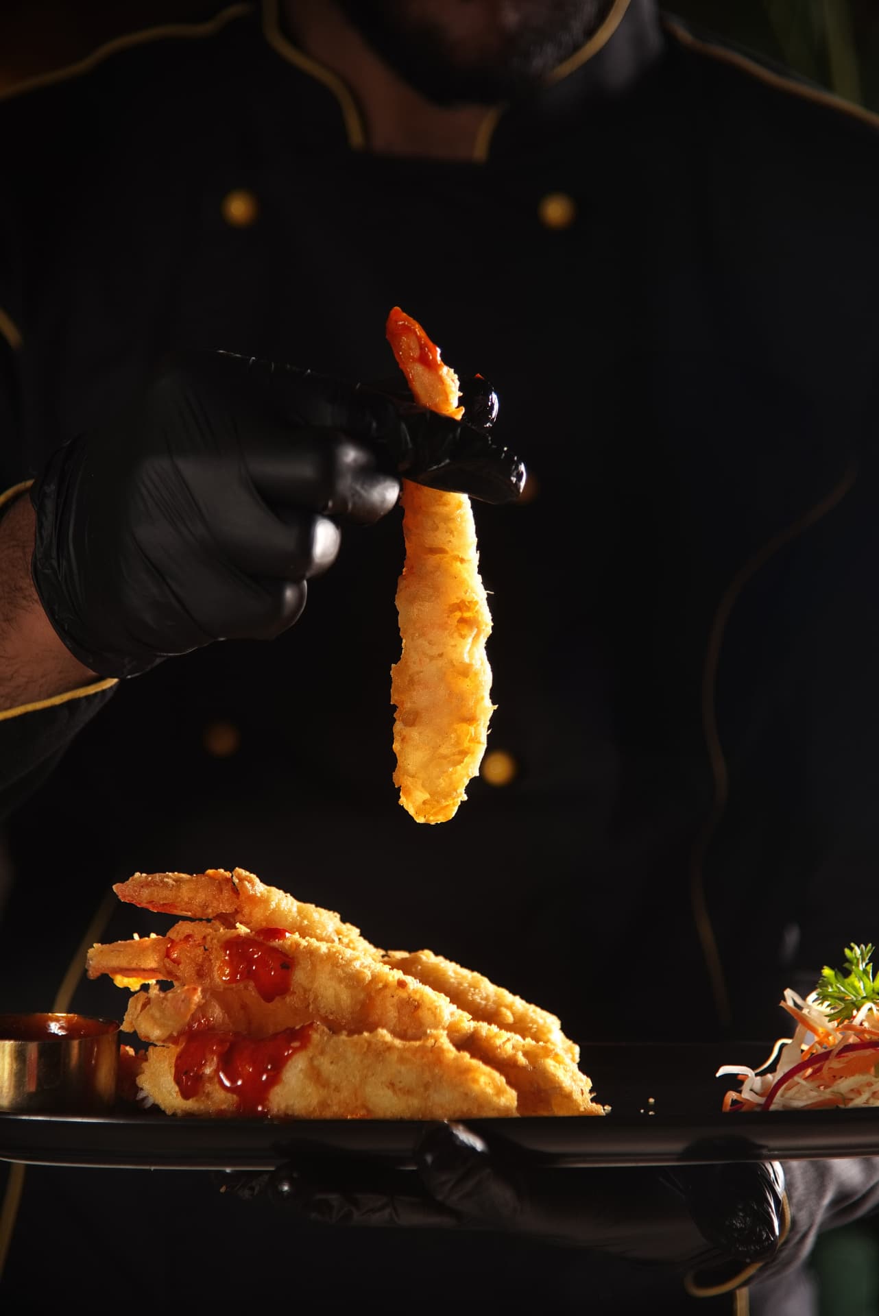 Chef presenting tempura prawns