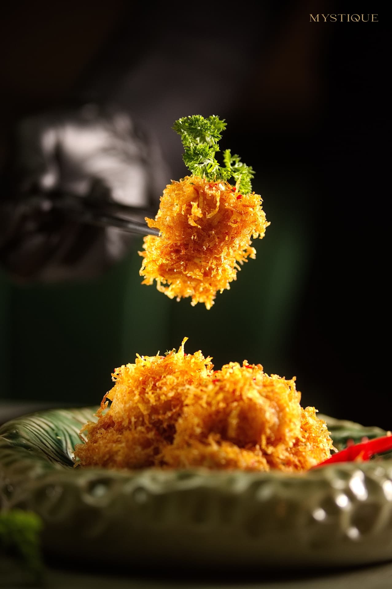 Golden crispy starter lifted with chopsticks