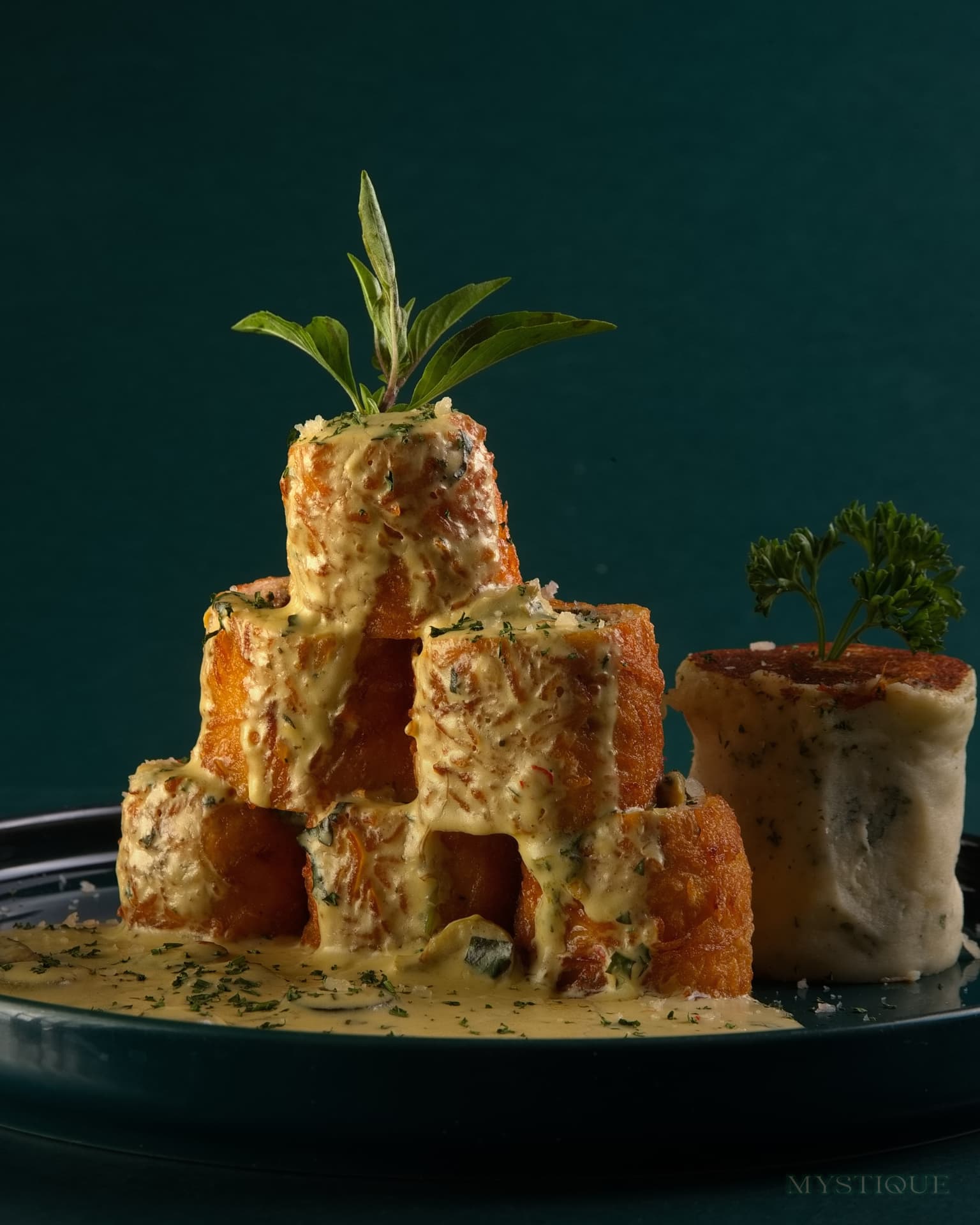 Golden fried cheese tower in velvety sauce