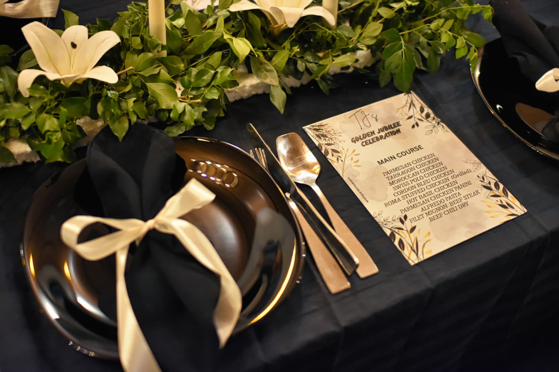 Lounge One celebration place setting with flowers and menu