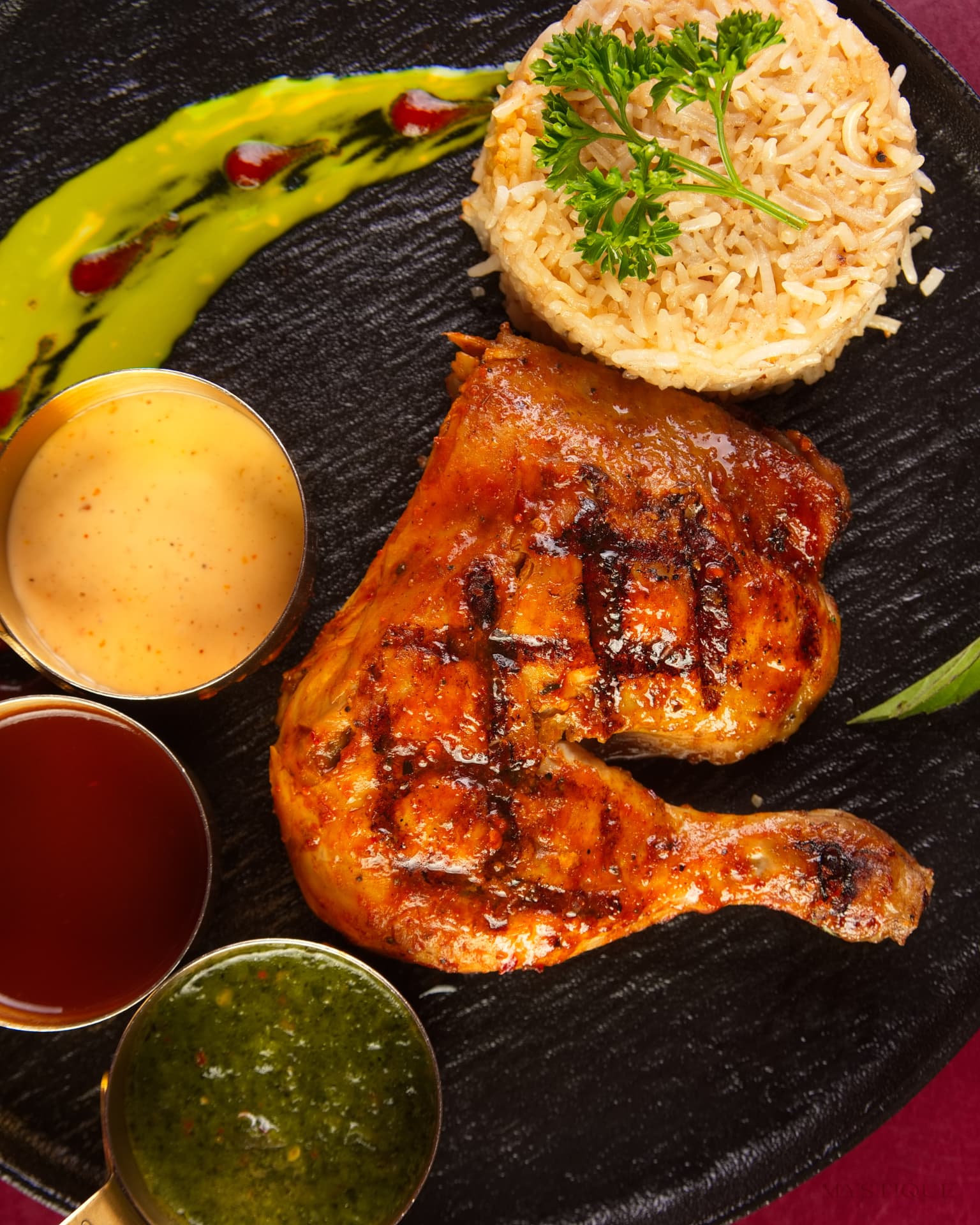 Char-grilled chicken with saffron rice and dips